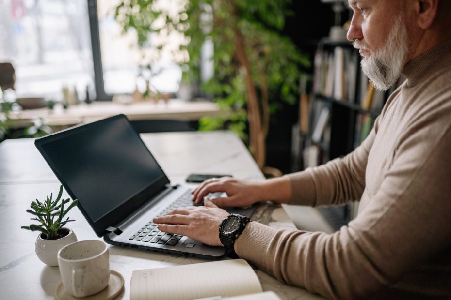 Man thinking how to become a better blogger and networker at laptop